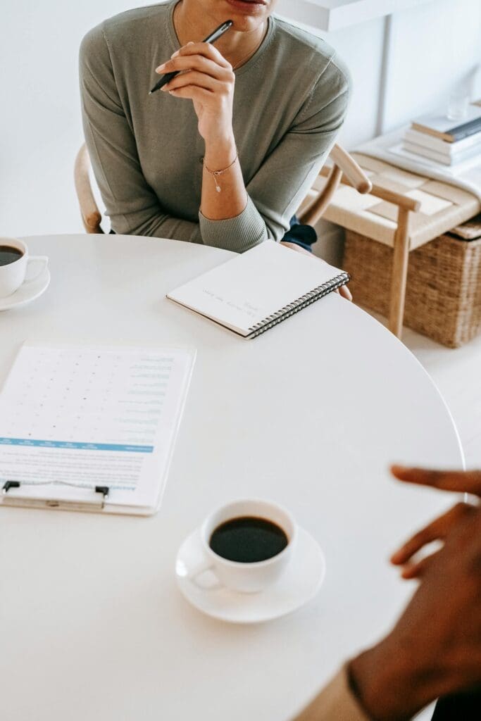 Cropped faceless therapist speaks with non-visible client across a table, one type of traditional therapy that can work for some teens but not all